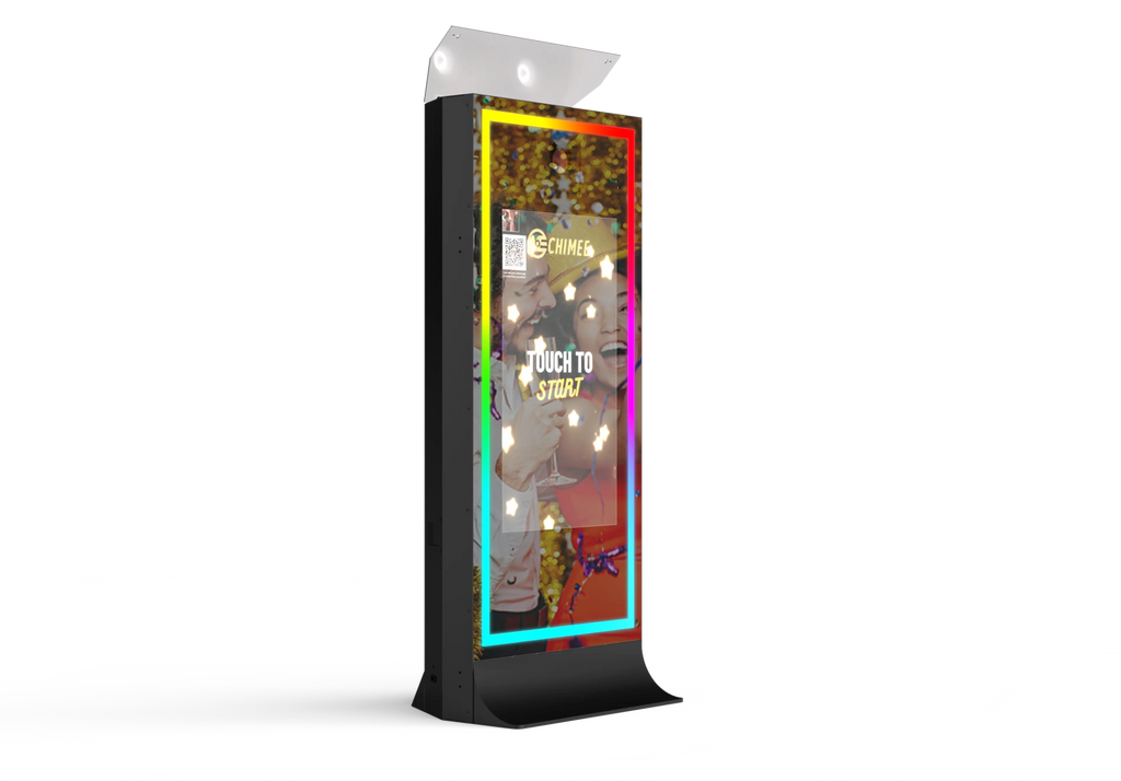 Black tower mirror photo booth with illuminated screen showing group photo
